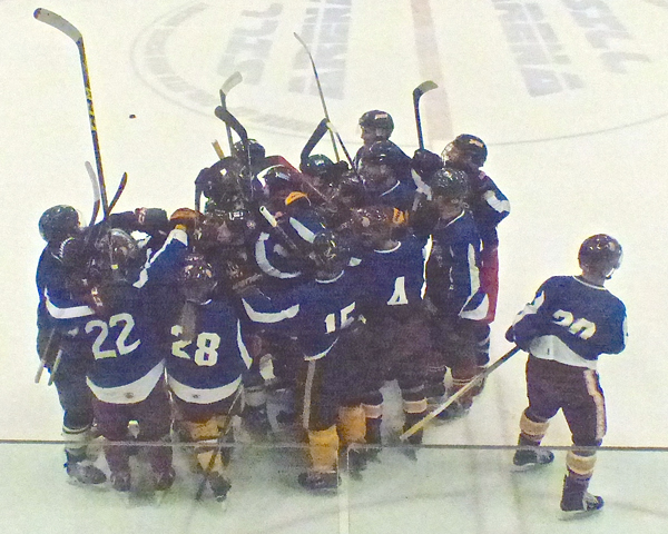 UMD women's hockey captain Ashleigh Brykaliuk (9 in Blue) was completely engulfed by her Bordson teammates after scoring in the third overtime to win the Heritage Classic 3-2. Photo credit: John Gilbert