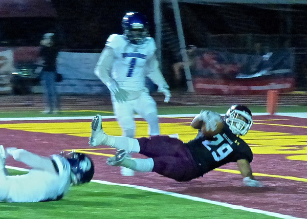...and lands in the end zone with the game-winning TD. Photo credit: John Gilbert