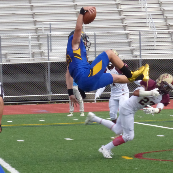 While passing for five touchdowns, St. Scholastica quarterback Kyle Stepka took flight for one himself... photo credit: John Gilbert