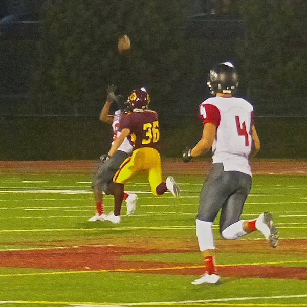 East's Joshua Daniels-Hanbury was barely visible behind Denfeld's Dominic Klaas (36) as Jack Rashid's fourth-down bomb dropped into his hands for a 70-yard touchdown -- his third of the game. Photo credit: John Gilbert