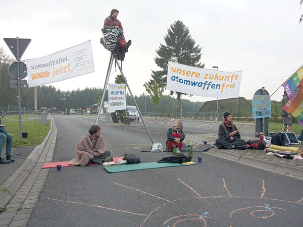 Blocking the main gate to Buchel Air Base in Germany, civil resisters's banners declare: "Our Future: Nuclear Weapons-Free!" 