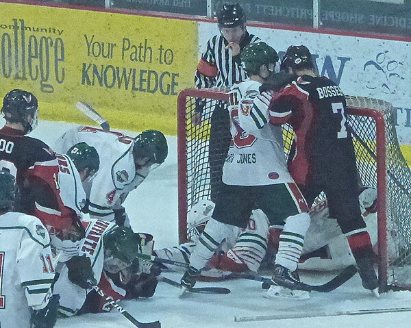 In a prelude to the goal, the Wilderness defense kept Tyler Bossert away and pinned Aberdeen goal-scorer Colin Raver to the ice until goalie Trevor Micucci could cover the loose puck. Photo credit: John Gilbert