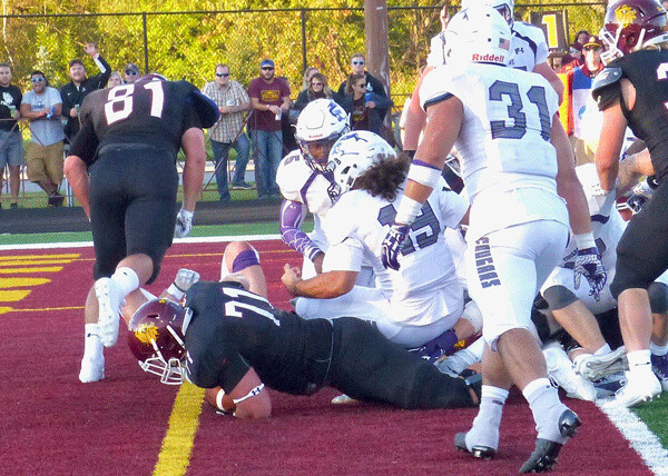 Tackle Nolan Folkert shifted to running back and used his 295-pound heft to crash into the end zone to give UMD life at 17-7. Photo credit: John Gilbert
