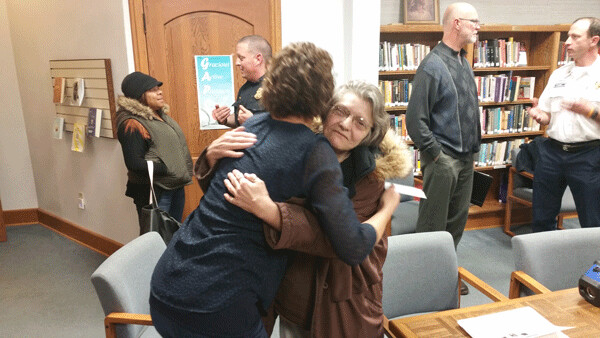Auld acquaintance: Mayor Emily Larson gives Louks a hug. Photo credit: Richard Thomas