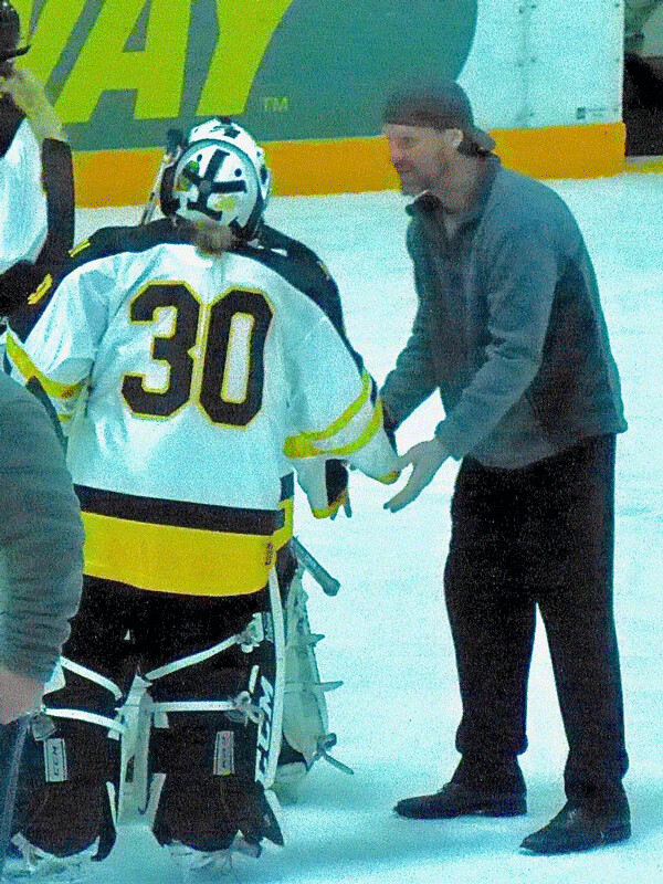 Former UMD star Shjon Podein, first-year coach at Benilde-St.Margaret's, congratulated Marshall goalie Carissa Mudrak after the Red Knights won 4-1 at Mars-Lakeview Arena. Podein's daughter, Anna, is a freshman defenseman for Benilde. Photo credit: John Gilbert