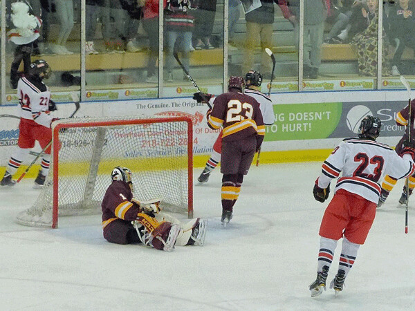 East's whole line rushed the Denfeld net, with Garrett Worth scoring his third goal and looking back at Ryder Donovan (22) who passed the puck to him, and Ian Mageau (23) joined the celebration. Photo credit: John Gilbert