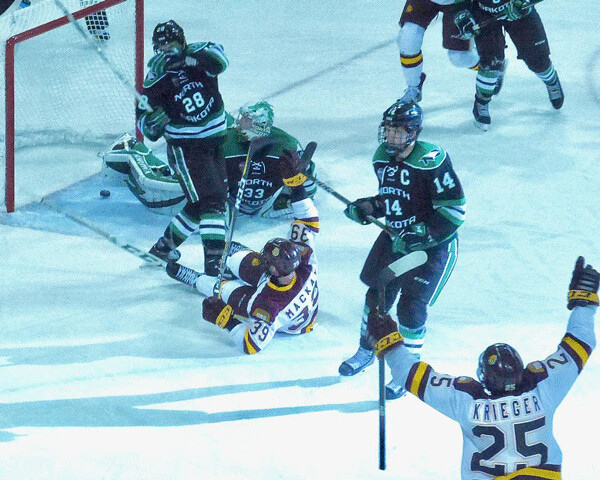 ..Despite being sprawled on his back, Parker Mackay had the wherewithall to raise his arm in  celebration for the goal that clinched UMD’s second-game 5-2 victory. Photo credit: John Gilbert