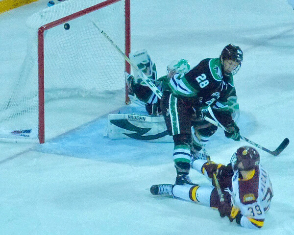 ..By the time Parker Mackay landed flat on his back, the puck was caroming back out off the roof  of the net... Photo credit: John Gilbert