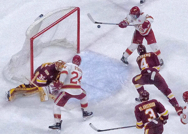 Denver’s Troy Terry was just about to smack a legally-high rebound into the UMD goal, but the officials disallowed the goal to keep the score 2-1. Photo credit: John Gilbert