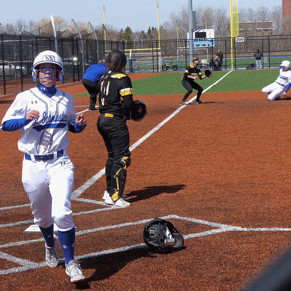 Saints pinch-runner McKenna Slagel crossed the plate to put the Saints ahead 6-5, as Cremers could be seen sliding into third. Photo credit: John Gilbert