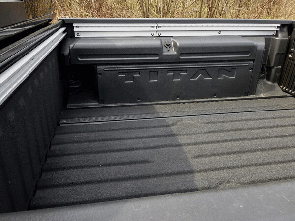  Pickup bed shows liner, adjustable tie-down slots, storage bins along either wall. Photo credit: John Gilbert