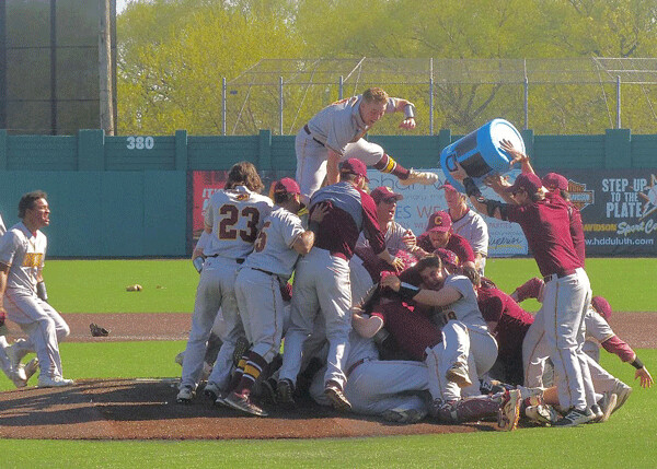 The Concordia Chicago Cougars swarmed ace reliever Mike Formella on the mound after the senior, and tournament MVP, won his third pitching decision of the NCAA regional in his only start of the season, 3-2 over Wisconsin-Oshkosh in the final game. Photo credit: John Gilbert
