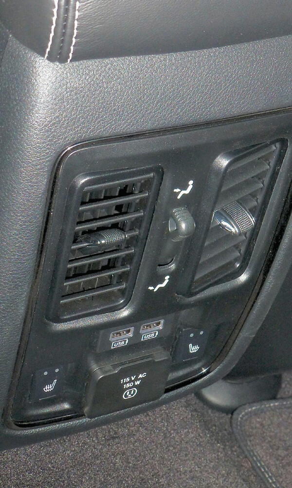 Control panel for rear seats includes household plug-in, DVD controls and USB connectivity. Photo credit: John Gilbert