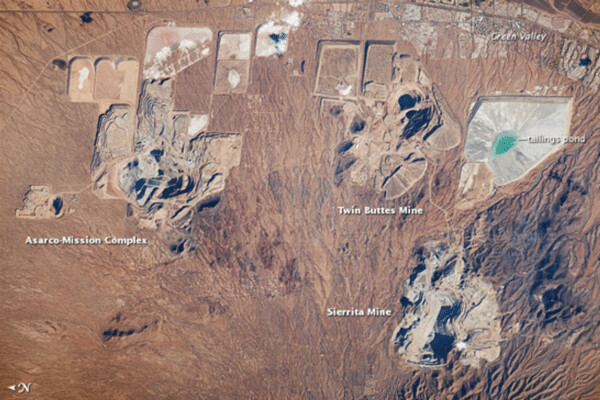 The Bingham Canyon Mine in Utah is one of the largest open-pit mines in the world. It measures over 4 kilometers wide and 1,200 meters deep and is located about 30 kilometers southwest of Salt Lake City. It was operated by Kennecott Copper Company until Rio Tinto purchased Kennecott Utah Copper in 1989. NASA Satellite photo.
