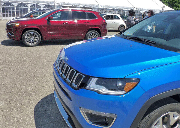 Jeep’s new Cherokee has the high-tech new 2.0-liter turbo 4, unlike its smaller Compass cousin in the foreground. Photo credit: John Gilbert