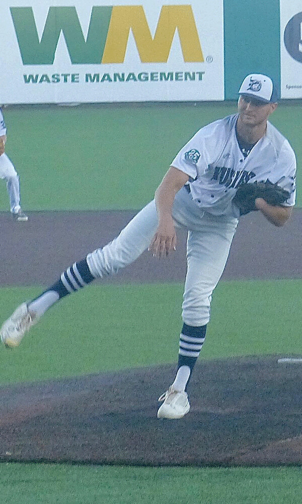 With a quick switch, Hanson grabs his glove with his right hand after he pitches. Photo credit: John Gilbert