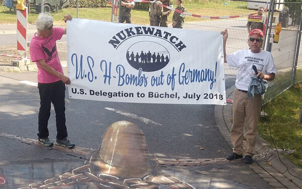 Susan Crane (L) of Redwood City, Calif.  and John LaForge of Nukewatch send  a message at the main gate at Buchel Air Base in Germany July 15.