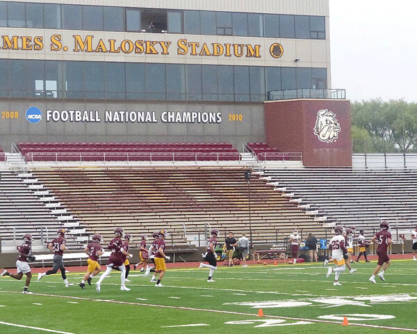 The grandstand was empty but the field was full as UMD’s football team opened practice by hustling among several drill stations during Tuesday’s first day of practice. Photo credit: John Gilbert