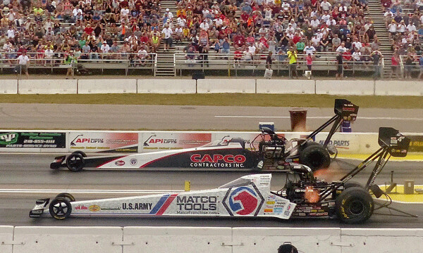 Billy Torrence (far lane) completed his day of upsets with his first Top Fuel title, beating favored Antron Brown by 0.001 seconds at the end of the quarter mile. Photo credit: John Gilbert