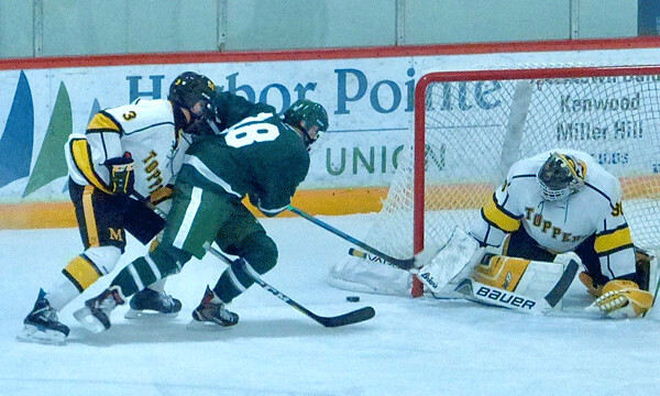 Marshall’s 6-foot-5 goaltender Alex Busick smothered a shot by Mounds View’s Ryan Collins at Mars-Lakeview Arena. Photo credit: John Gilbert