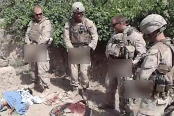 An image from a video uploaded in January 2012 shows Marines urinating on the bodies of dead Taliban fighters in Afghanistan and then posing for photos with the corpses. US Marine Staff Sgt. Edward W. Deptola later pleaded guilty to desecration of remains in a January 2013 court-martial at Camp Lejuene, NC. Photo, Military.com Daily News.