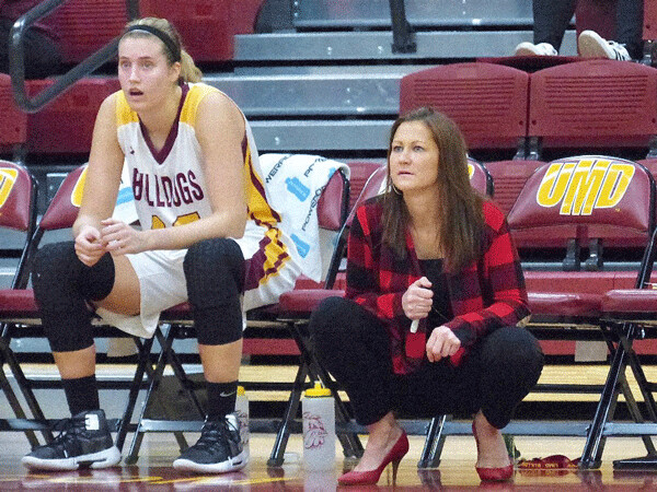 A frustrated Sarah Grow took a break on the bench next to UMD coach Mandy Pearson as the Bulldogs fell to Michigan Tech 66-57..  Photo credit: John Gilbert