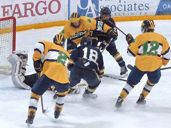 Hermantown sophomore Joey Pierce (18) went hard to the net, but found Rosemount goalie Will Tollefson already on top of the loose puck. Photo credit: John Gilbert