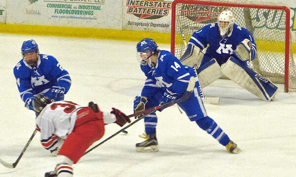 East’s Zarley Ziemski couldn’t get to a rebound because Minnetonka’s A.J. Kittelson, left, and Will Crull protected goalie Charlie Glockner.  Photo credit: John Gilbert