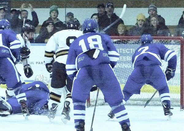 Hermantown's Brady Baker (9 in white) fed barely visible Blake Biondi at the left edge for the game-tying goal with 1:14 remaining fore Saturday's 3-3 tie with Minnetonka. Photo credit: John Gilbert