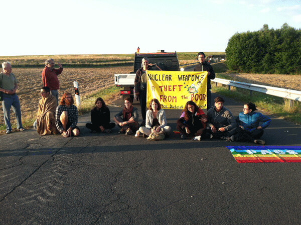Photo: International student group blockades one of the major gates to Büchel Air Base  last July. Photo by John LaForge