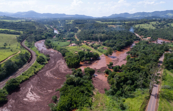 View of toxic sludge in a large river - showing a tributary to the right where the sludge presumably moved upstream momentarily against the flow (note the fresh blue water - right upper corner of photo)