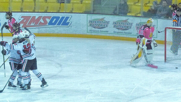 Wearing commemmorative Breast Cancer Awareness jersey, UMD goalie Maddie Rooney retrieved  the puck after Taylor Wemple (12) scored what proved to be the 3-2 game-winner.  Photo credit: John Gilbert