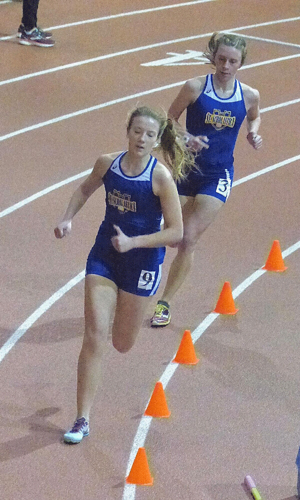 St. Scholastica's Maria West led her favored teammate Aria Plewa to a 1-2 finish in the UMAC indoor track meet's mile run in 5:14.94. Photo credit: John Gilbert