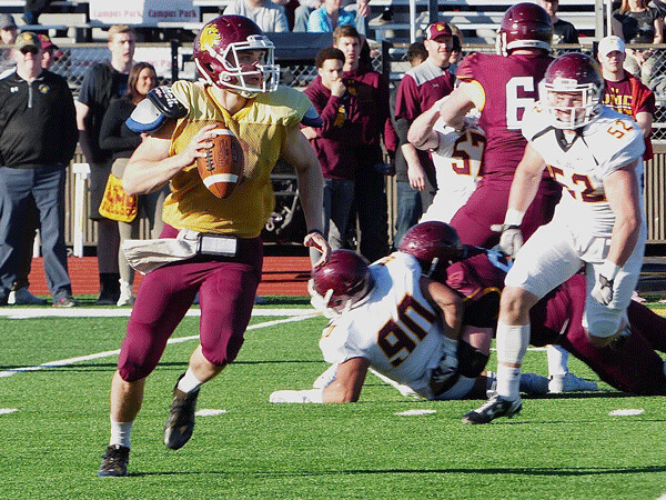Sophomore Garrett Olson rolled out while directing the Maroon team to a 6-0 victory in UMD’s  annual spring game. Photo credit: John Gilbert