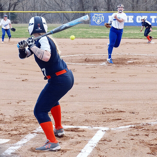 St. Scholastica freshman pitcher Olivia Howe sends a pitch toward Northland’s  Alivia Heller in the Saints long-delayed “home” opener. Photo credit: John Gilbert