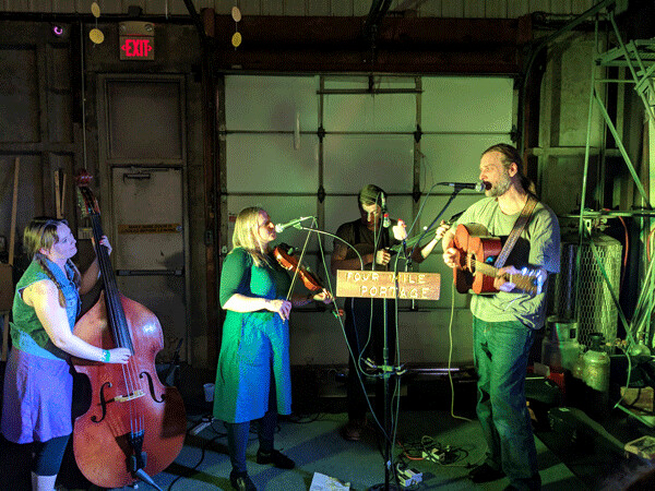 Four Mile Portage at Lake Superior Brewing on Craft District Night. They sang, they  clogged, they played a variety of string instruments in tamarack dance style.  Photo by Felicity Bosk.