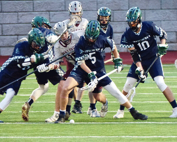 Chaos? No, lacrosse. Hermantown-Proctor's Cody Une (5) shielded the ball from Duluth Wolfpack Erik Hokans during their Section 7A quarterfinal. Photo credit: John Gilbert