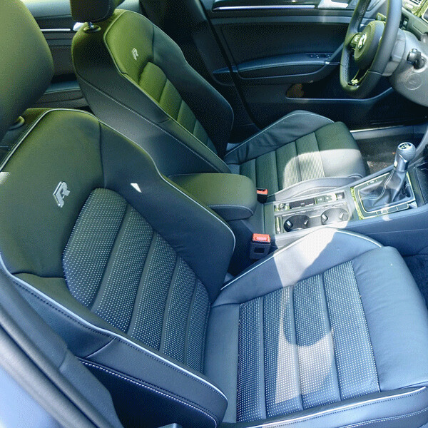 The “R” emblem points out that the encapsulating bucket seats are special in this  model. Photo credit: John Gilbert