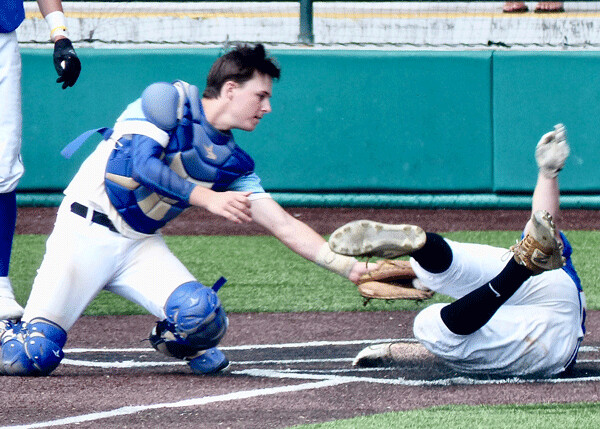 Tyler Johnson of the West Duluth Cubs was called safe at home, although Brainerd catcher Josh Hukried put the tag on him... Photo credit: John Gilbert
