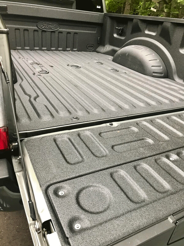 Ford Super-Duty has the innovative tailgate leading to sprayed bedliner of its bed. Ram's is longer, however. Photo credit: John Gilbert