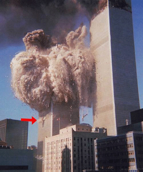 Image of the World Trade Center’s South Tower as it explodes, from top to bottom, into fine dust and severed steel columns. Within the next 12 seconds much of the tower blows away and the rest collapses into its own footprint into a relatively small pile of debris. The arrow points to one of the exploding “squibs” from one of the multitude of pre-planted demolition charges that are intended to section all the massive steel 110 story columns (4 inches thick at their bases) which allowed the building to fall straight down rather than falling sideways and causing damage to adjacent structures or people. This image is typical of what it looks like when standard controlled demolitions take down high-rise buildings in the most cost-effective manner possible. In the 100 year history of skyscrapers, the only tall buildings that have ever fallen down without controlled demolitions (allegedly) were the 3 World Trade Center Towers 1, 2 and 7 - and they all happened on 9/11/201!.  (Check out www.ae911truth.org for everything you need to know about the many anomalies that conclusively disprove the “official”, CIA-, Pentagon- White House- Mainstream Media-approved conspiracy theories about what happened of 9/11.)  Image supplied by Gary Kohls.