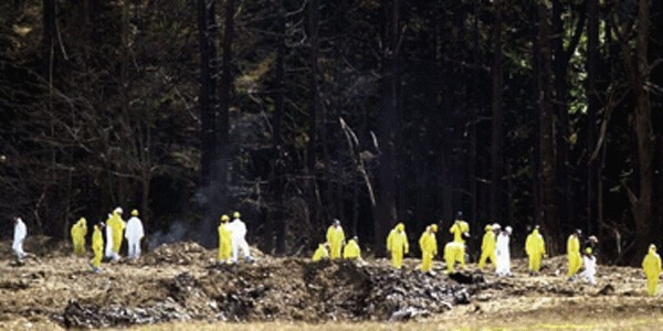 Investigators comb the alleged crash site for evidence from United Airlines Flight 93 near Shanksville, Pennsylvania, the day after 9/11