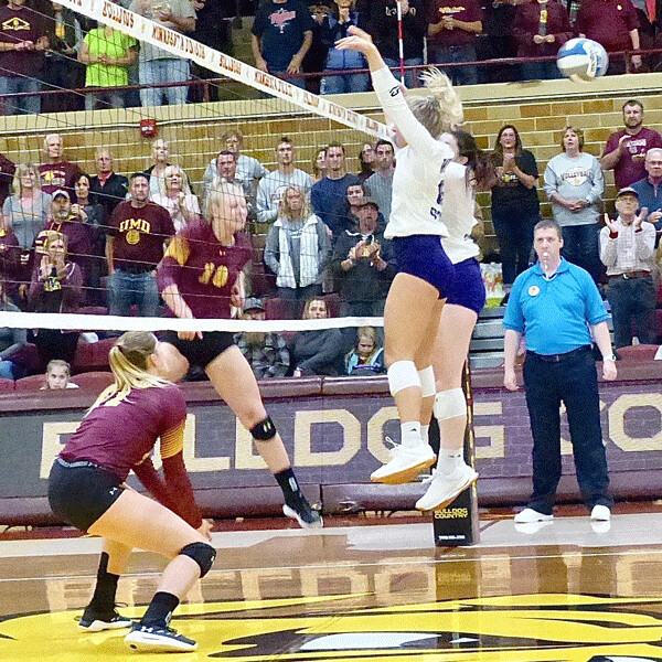 UMD's Brooke Scheurer rapped the ball through Winona's double block as the Bulldogs swept a 3-0 victory. Photo credit: John Gilbert