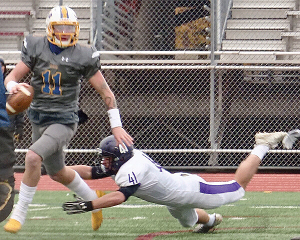  St. Scholastica quarterback Zach Edwards (11) threw four touchdown passes and ran for a fifth in the 61-8 romp over Iowa Wesleyan. Photo credit: John Gilbert