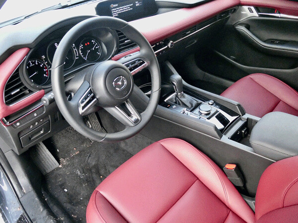 Red leather seats, heated and cooled, set off the refined interior of the Mazda3. Photo credit: John Gilbert