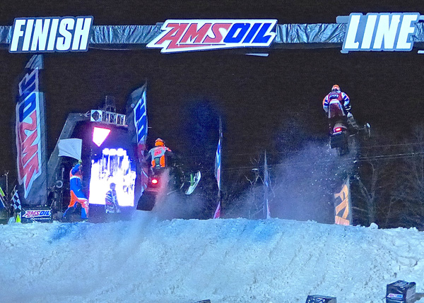 Tucker Hibbert, left, hit the finish line on his Arctic Cat simultaneously with Kyle Pallin's Polaris but Pallin won the Dominator semifinal by 0.048-seconds in the best race of the 25th AMSOIL Snocross. Photo credit: John Gilbert